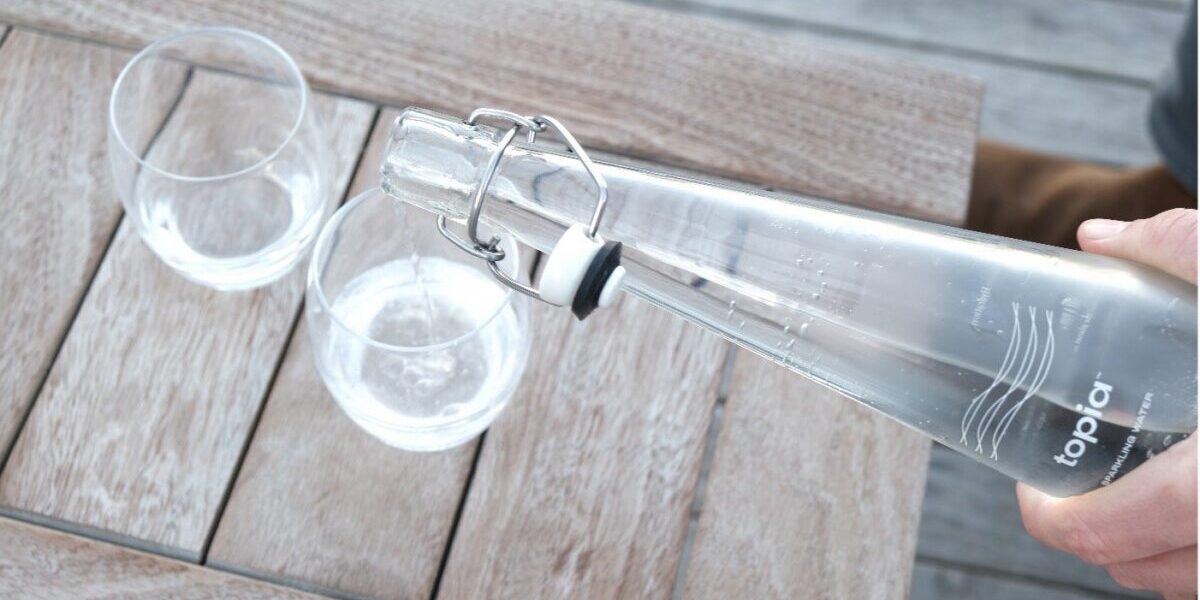 Pouring Filtered Topia Water Into Glasses