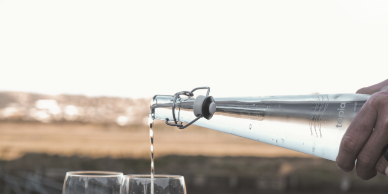 Pouring Water In Glass From Topia Glass Bottle