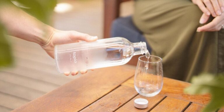Pouring Filtered Water From Topia Bottle