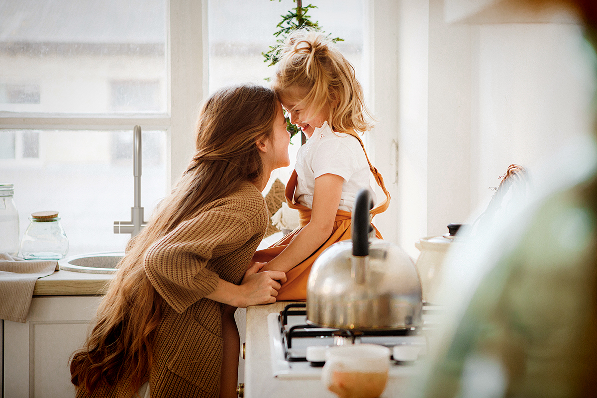 Mother & Daughter In Kitchen With Topia Tap